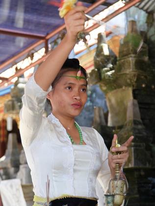 Ida Resi Alit turns pails of ordinary water into holy water. Picture: Ian Lloyd Neubauer