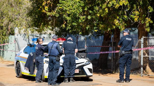 Police gather at on Lewis Street at one of four crime scenes. Picture: EMMA MURRAY