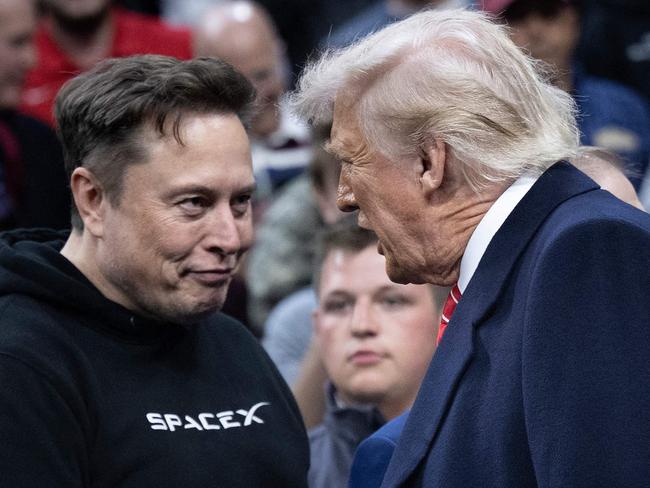 Aussies are not fans of Donald Trump’s key adviser, billionaire Elon Musk. The pair are pictured at the men's NCAA wrestling competition at the Wells Fargo Center in Philadelphia, Pennsylvania, on March 22. Picture: Brendan Smialowski / AFP