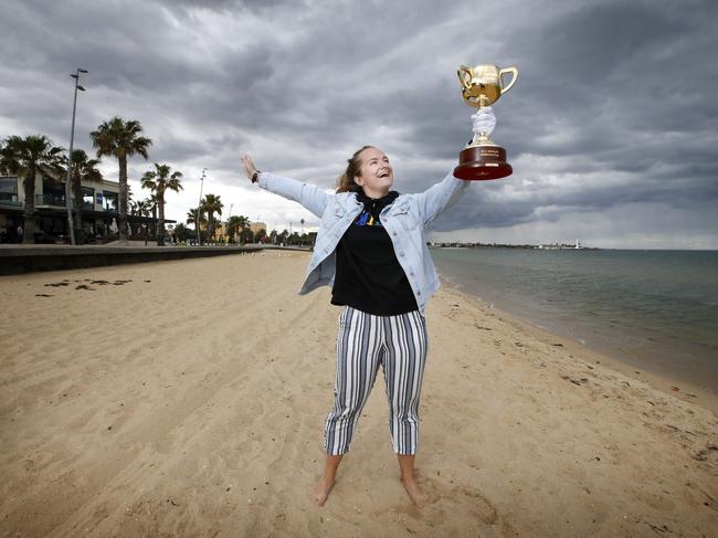 Amy Gillard from the UK raises the Cup on St Kilda Beach. Picture: David Caird