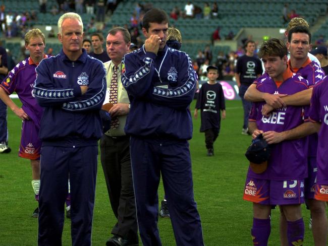 digital image  news  soccer final  Perth Glory coach Bernd Stange far left and team members after Glory lost the final to Wollongong 3-3 and 7-6 on penalty shoot out and Scott Miller with James Afkos who missed the final shot far right of the picture PIC IAN CUGLEY