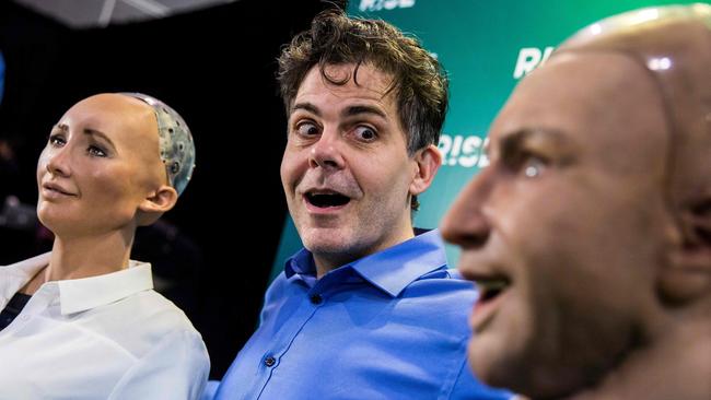 David Hanson, chief executive officer of Hanson Robotics, reacts to "Han the Robot" and "Sophia the Robot" after a discussion about the future of humanity in a demonstration of artificial intelligence (AI) by Hanson Robotics at the RISE Technology Conference in Hong Kong on July 12, 2017. Picture: Isaac Lawrence