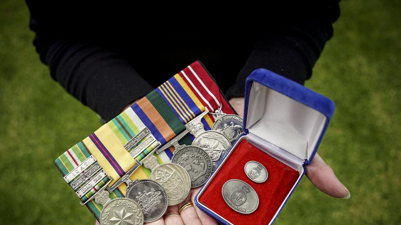 Julie-Ann Finney holds her son David Finney’s service and commendation medals. The Navy engineer took his own life after a battle with PTSD. Picture: Mike Burton