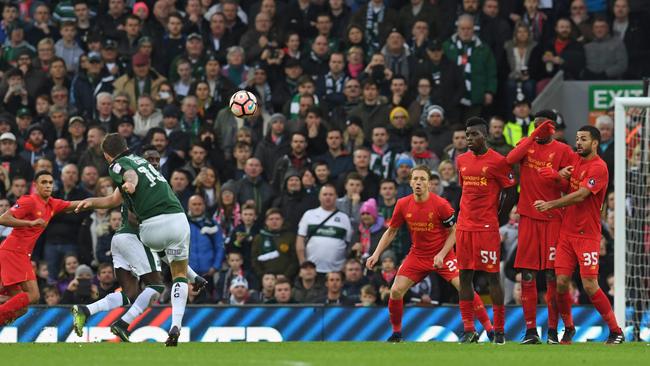 Plymouth's Irish midfielder Graham Carey (2nd L) takes a freekick.