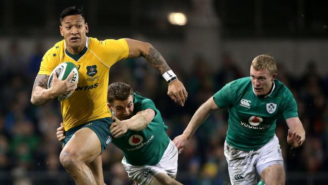 Australia's Israel Folau, left, is tackled by Ireland's Garry Ringrose during the rugby international match between Ireland and Australia at the Aviva Stadium in Dublin, Ireland, Saturday, Nov. 26, 2016. (Niall Carson/PA via AP)