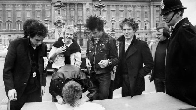 The Sex Pistols signs a new contract outside Buckingham Palace in 1977. Picture: AP Photo