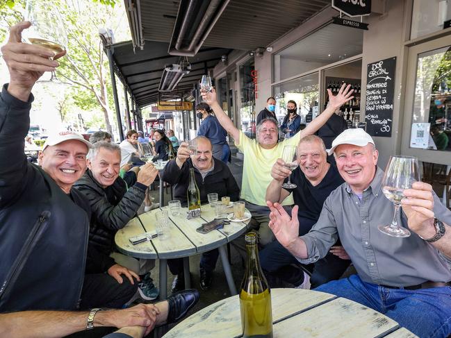 Friends celebrate in Lygon Street in Carlton as Melbourne’s lockdown lifts. Picture: NCA NewsWire / Ian Currie