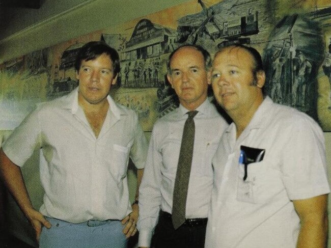 IM Holdings Limited director Buchanan (centre) presenting "The Story of Collinsville" mural to Workers' Club President Arch Tudehope (right). With them is Isa Mine Company artist Glen Graham. Picture: Mimag, Mount Isa Mines Limited, February 1985