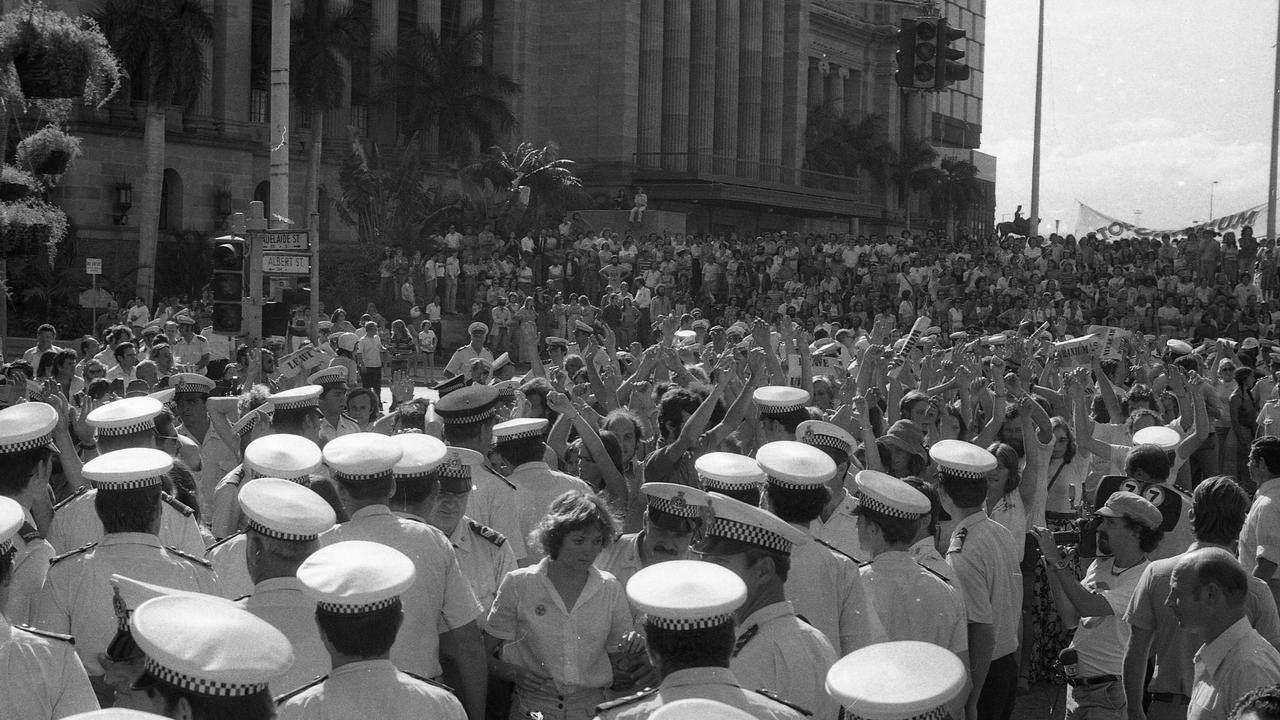 Anti-uranium protest, 1977. People hold up their arms to show they are not resisting arrest. Picture: Mike Moores