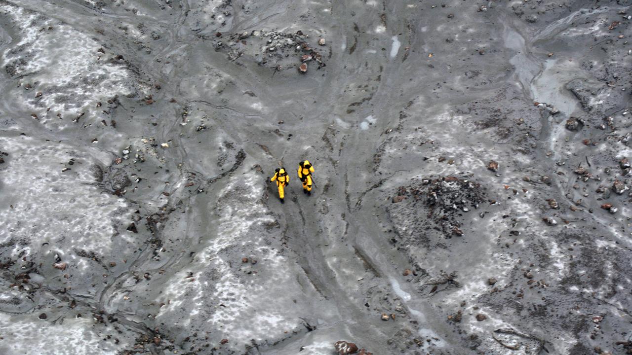 Working in pairs, the SAS soldiers wore Hazmat suits against the hot steam and noxious gases on White Island. Picture: NZDF.