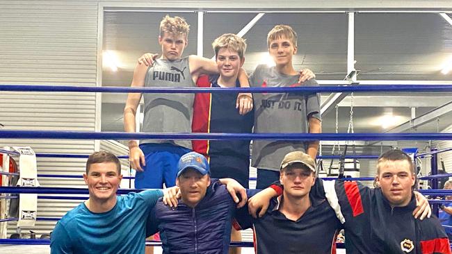 Warwick Boxing Club head trainer Damien Lawler (front: second from left) and son, Kye Lawler (top left) with other members of the club.