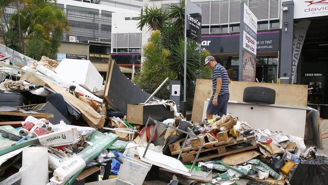 A man cleaning up outside a business in Milton. Picture: Tertius Pickard