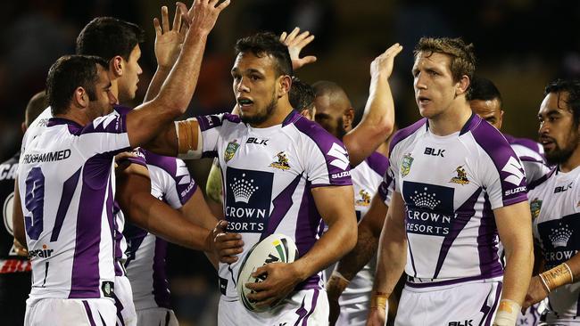 Storm players celebrate a Will Chambers try in their win over the Tigers. Pic: Brett Costello