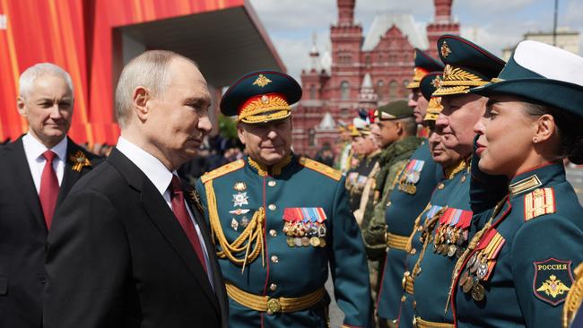 Vladimir Putin greets military commanders after the Victory Day military parade