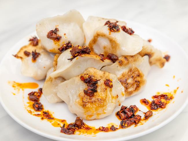 Steamed beef dumplings doused in crunchy chilli oil makes the ultimate courtside lunch. Picture: Brendan Beckett