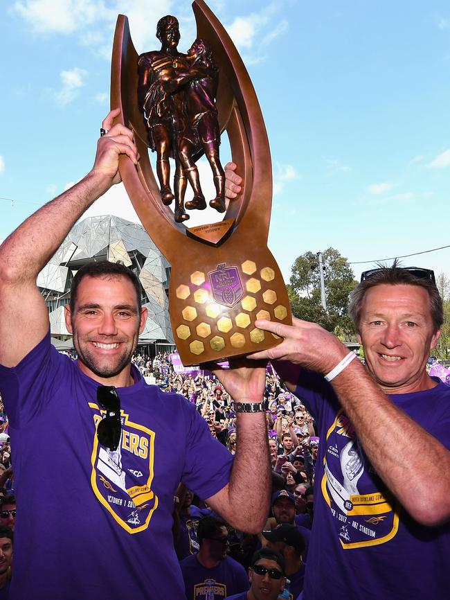 Sorry, boys... You’ve got nothing on this race. Cameron Smith and Craig Bellamy of the Storm hold up the NRL premiership trophy. Picture: AAP