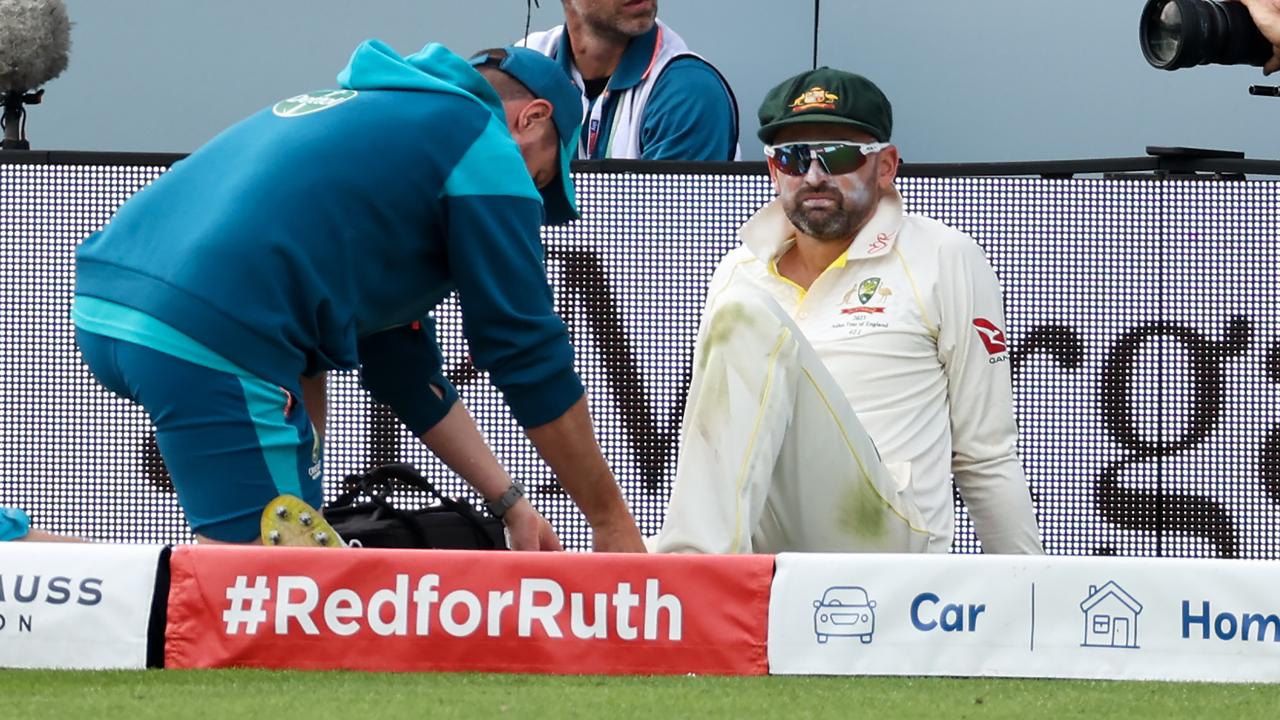 Nathan Lyon of Australia leaves the field injured. Photo by Ryan Pierse/Getty Images