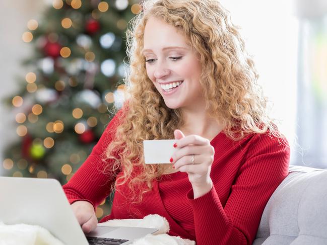 A young woman is shopping online and ordering Christmas presents. Picture: iStock.