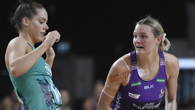 CAIRNS, AUSTRALIA – SEPTEMBER 20: Tippah Dwan of the Firebirds looks to pass the ball past Tayla Honey of the Vixens during the round 13 Super Netball match between the Melbourne Vixens and the Queensland Firebirds at the Cairns Pop Up Arena on September 20, 2020 in Cairns, Australia. (Photo by Ian Hitchcock/Getty Images)