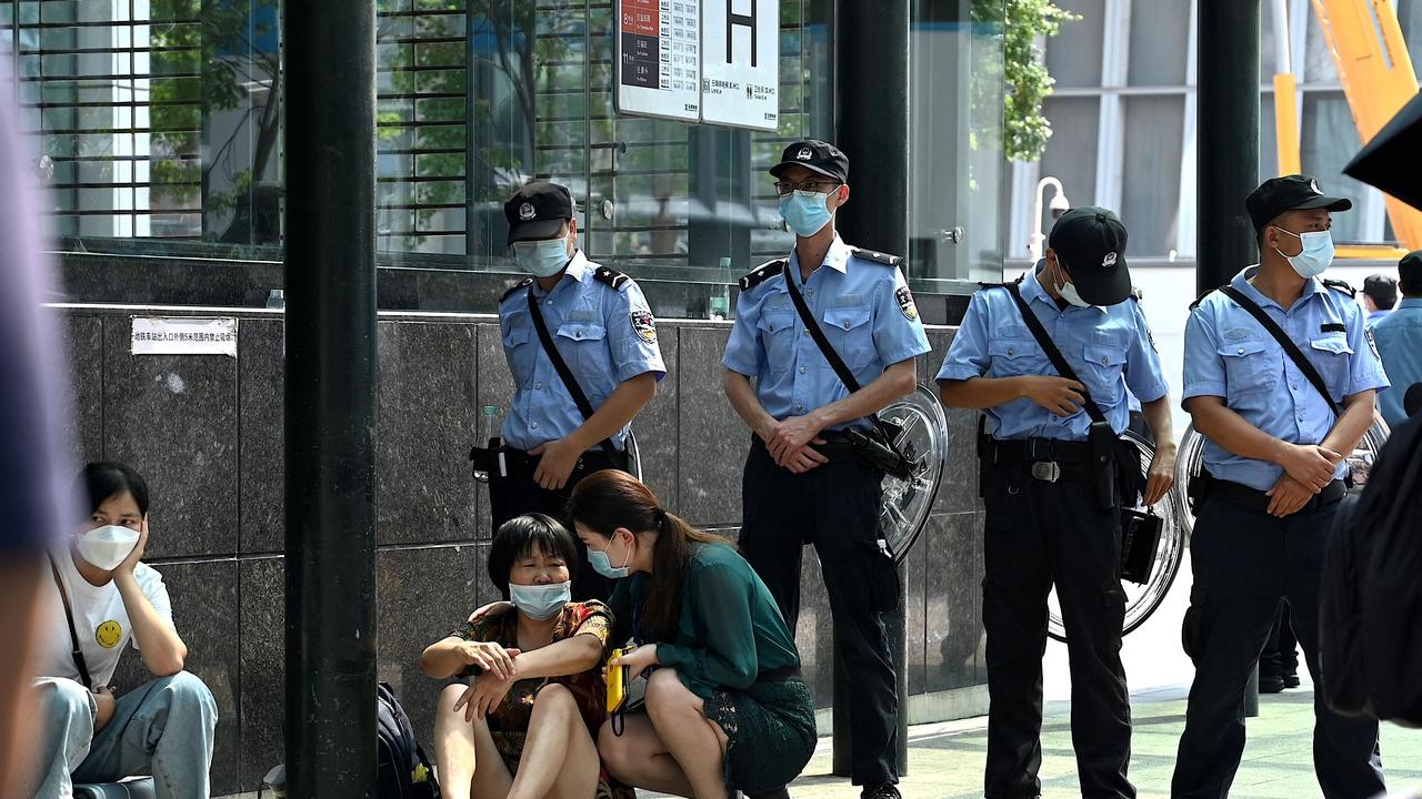 People gather at Evergrande’s headquarters amid fears it is about to go under. Picture: Noel Celis/AFP