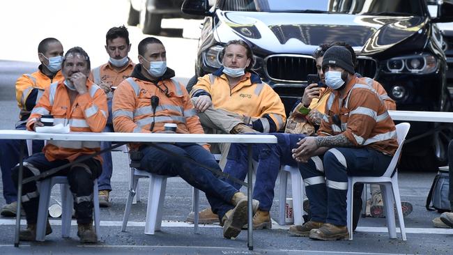 Construction workers set up an outdoor break room on the intersection of A’Beckett and Elizabeth streets in Melbourne. Picture: Andrew Henshaw