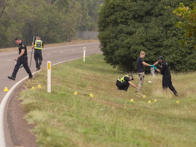 Police search the site where the leg was found.