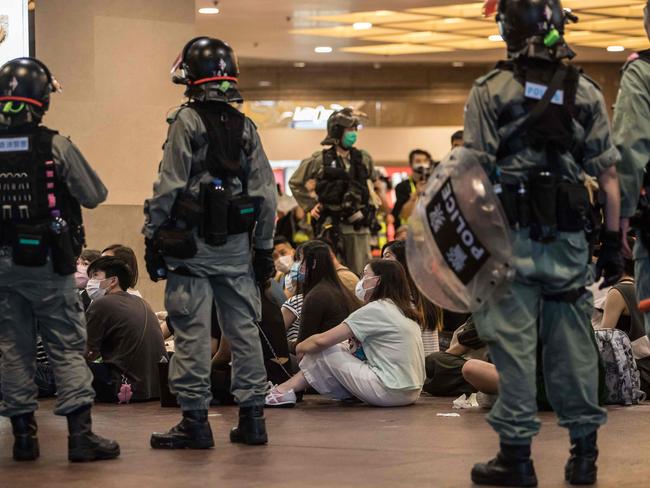 Riot police detain people after they cleared protesters taking part in a rally. Picture: AFP