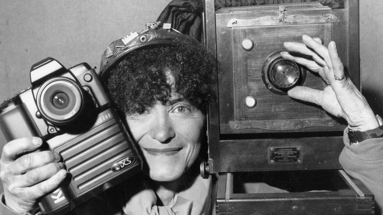 Exhibitor Anne Szilard-Oliver with Eastman's 1892 Kodak camera (right) and a Nikon N808S camera at Visions photography exhibition in Myer Rundle Mall in Adelaide. 