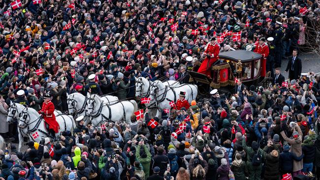 King Frederik X of Denmark and Queen Mary of Denmark make their way past crowds of wellwishers in their carriage . Picture: AFP