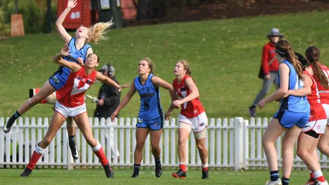 Sturt SANFLW player Zoe Prowse leaps over North Adelaide's Jane Altschwager. Picture: Peter Swan