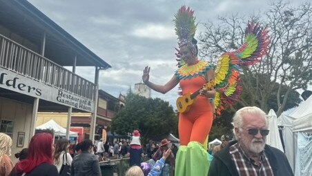 Women on stilts were walking up and down the street, posing and playing ukuleles.