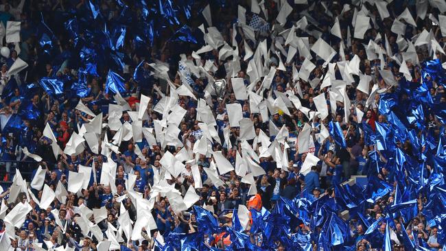 Leicester fans wave flags in the team colours before the match with Everton.