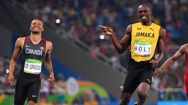 Usain Bolt jokes with Canada's Andre De Grasse during the Rio 2016 200m semi-finals.