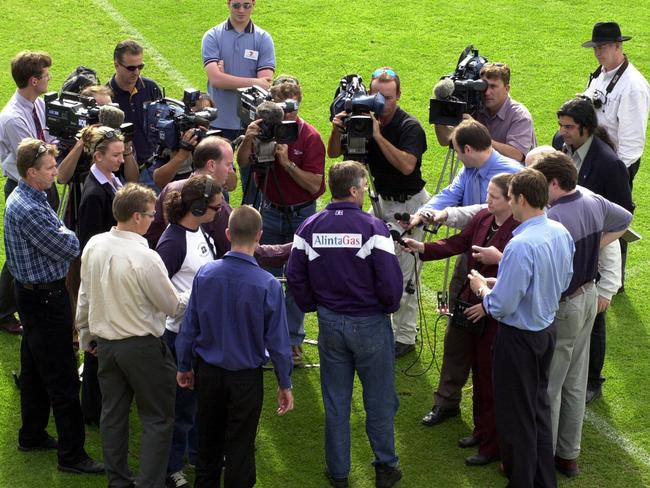 Damian Drum is flanked by the media during a press conference at Fremantle Oval.