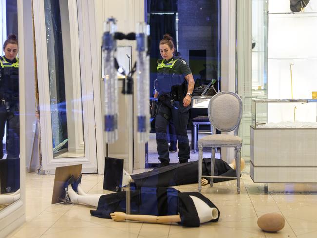 Police inspect the crime scene. Picture: Brendan Beckett