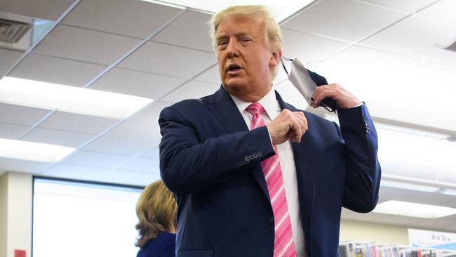 US President Donald Trump takes off his mask before speaking to the press after casting his ballot in the US election. Picture: Mandel Ngan/AFP