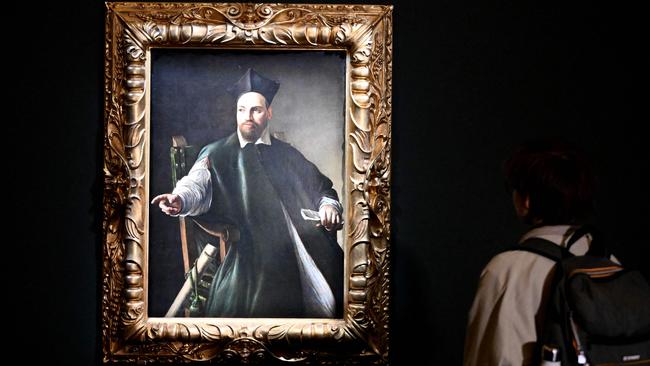 A visitor looks at a portrait of Maffeo Barberini by Italian master Caravaggio at the Gallerie Nazionali di Arte Antica in the Barberini Palace in Rome. It is the first time the painting has been on public display