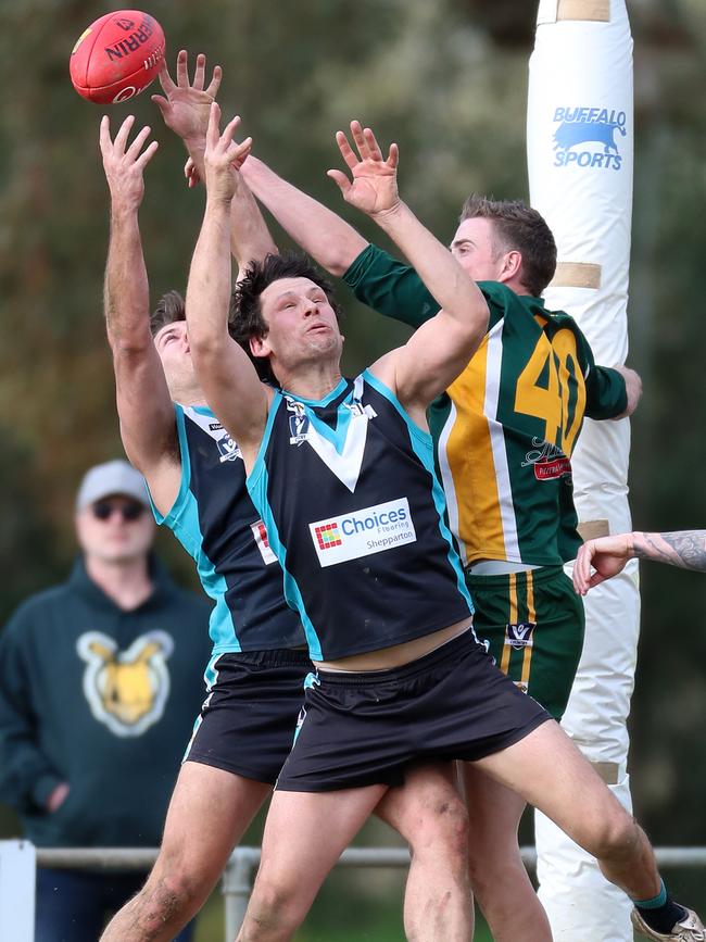 Murchison-Toolamba’s Andrew Lloyd punches the ball clear of Dookie United pair Joshua Kezerle and Kyle Tapscott.