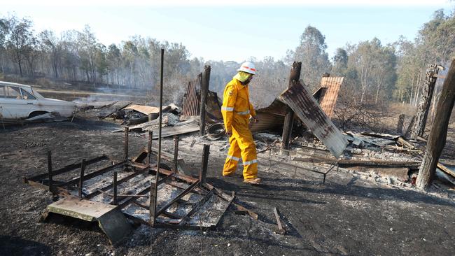 DESTRUCTION: Brett Nagel from the Rural Fire Brigade surveys damage on Spicers Gap Rd. Picture: Annette Dew.