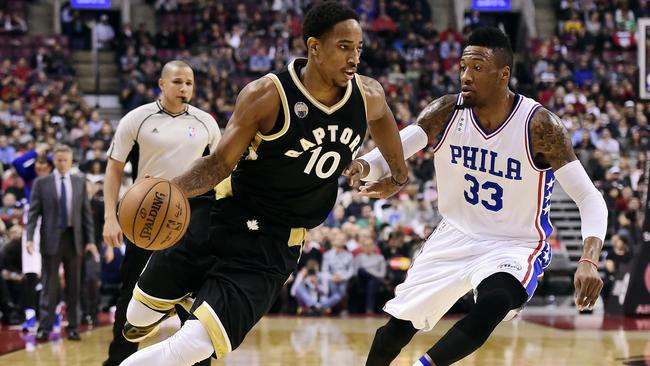 Toronto Raptors' DeMar DeRozan, left, drives past Philadelphia 76ers' Robert Covington during first half.