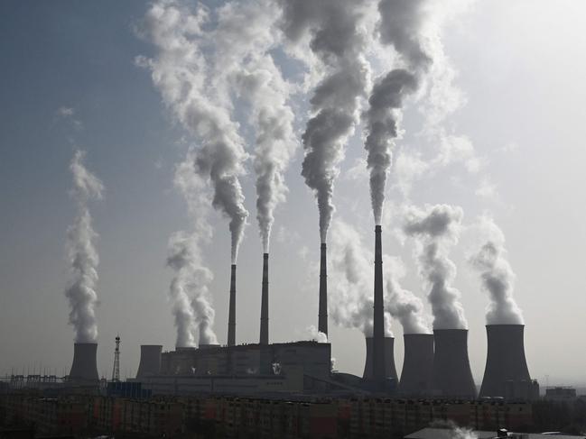 (FILES) This photo taken on November 15, 2021 shows the coal-powered Datang International Zhangjiakou Power Station in Zhangjiakou, one of the host cities for the 2022 Winter Olympic Games, in China's northern Hebei province. As climate envoys from the world's top two greenhouse gas producers meet in Beijing, experts say China's emissions may finally be nearing a peak, though many uncertainties remain. (Photo by GREG BAKER / AFP)