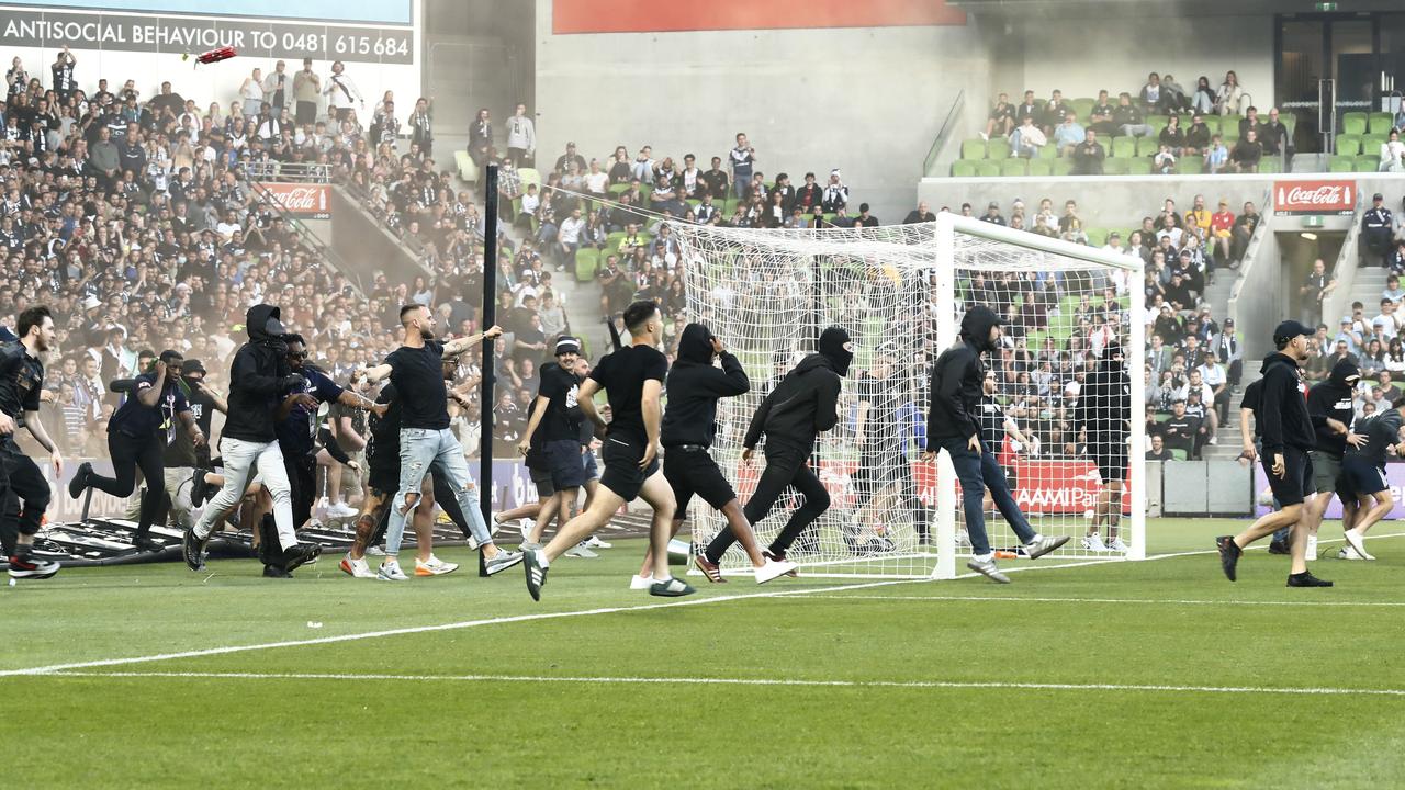 Spectators invade the field. Photo by Darrian Traynor/Getty Images.