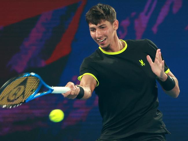 MELBOURNE, AUSTRALIA - JANUARY 07: Alexei Popyrin of Australia plays a forehand against Fabian Marozsan of Hungary during their Red Bull Bassline match ahead of the 2025 Australian Open at Melbourne Park on January 07, 2025 in Melbourne, Australia. (Photo by Kelly Defina/Getty Images)