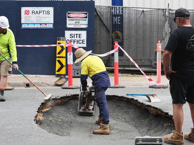 Workmen repair a sinkhole that appeared in the middle of George St Broadbeach at 10 am Friday morning. Picture Glenn Hampson