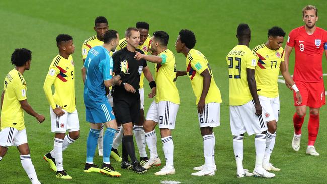 There’s something very wrong with this photo. Colombian photos surround the referee after he awarded England a penalty.