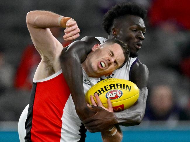 MELBOURNE, AUSTRALIA - MAY 02: Jack Higgins of the Saints is tackled by Michael Frederick of the Dockers during the round eight AFL match between St Kilda Saints and Fremantle Dockers at Marvel Stadium, on May 02, 2025, in Melbourne, Australia. (Photo by Quinn Rooney/Getty Images)