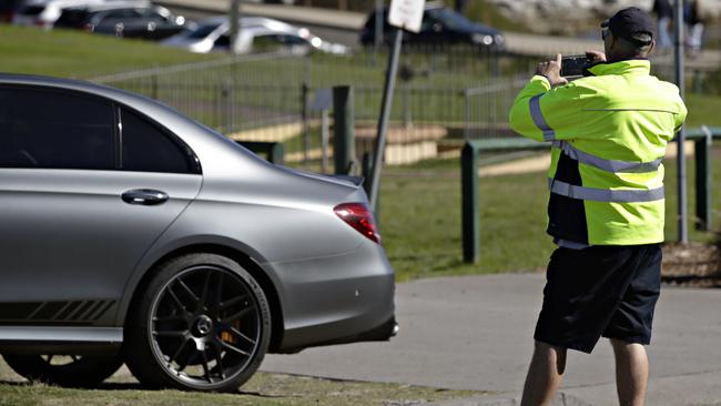 A parking ranger booking an illegally parked car in La Perouse. Picture: Adam Yip