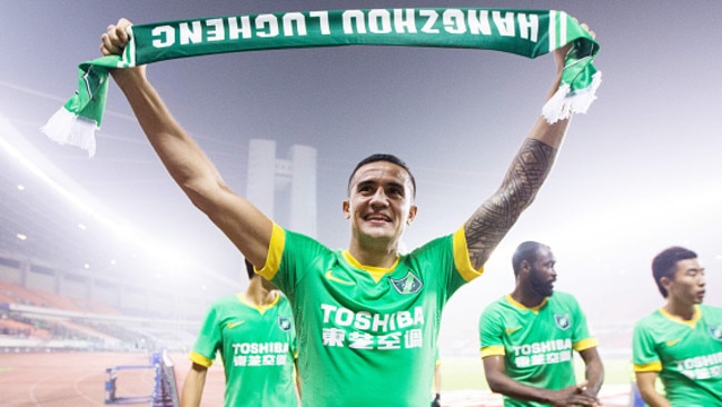 Cahill brandishes a Hangzhou Greentown scarf after his debut with the club. Picture: Getty Images