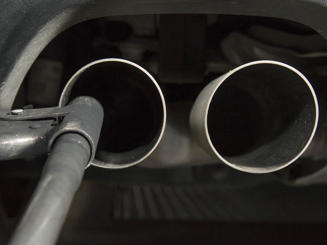 (FILES) This file photo taken on August 7, 2017 shows a hose for an emission test fixed in the exhaust pipe of a Volkswagen Golf 2,0 litre diesel car at the Technical Inspection Agency in Ludwigsburg, southwestern Germany. - German car giant Volkswagen said on February 14, 2020 it had offered 830 million euros ($900 million) to settle a mass lawsuit from German customers over its "dieselgate" emissions cheating scandal. But the proposed settlement with consumer group VZBV, representing 400,000 plaintiffs in a first-of-its-kind grouped proceeding, "failed" because of "disproportionate" pay demands from the VZBV's lawyers, a VW spokesman added. (Photo by THOMAS KIENZLE / AFP)