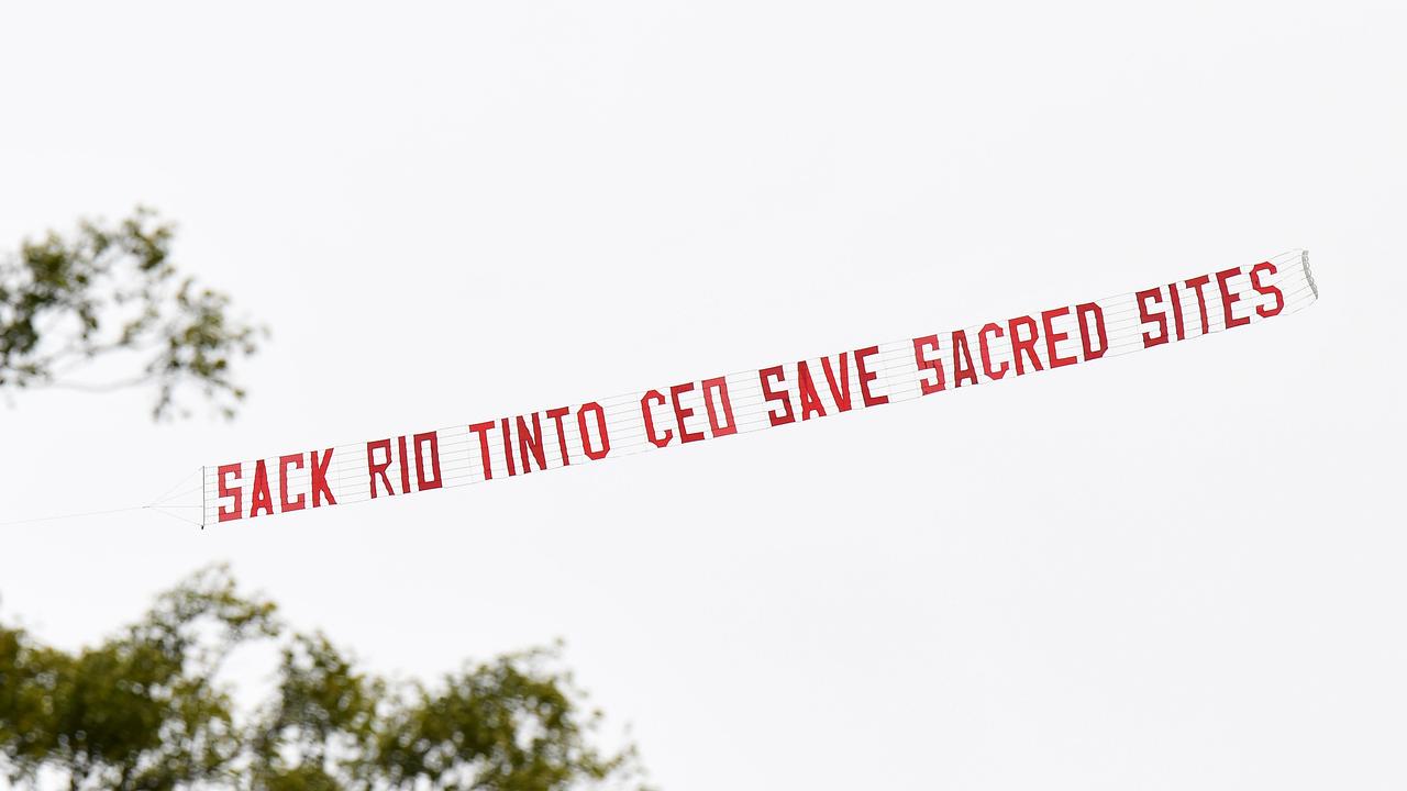 A sign towed by a plane over central Brisbane. Activist group GetUp had organised the protest sign, calling for the sacking of Rio Tinto’s CEO over the destruction of the Juukan Gorge caves. Picture: NCA NewsWire/Dan Peled